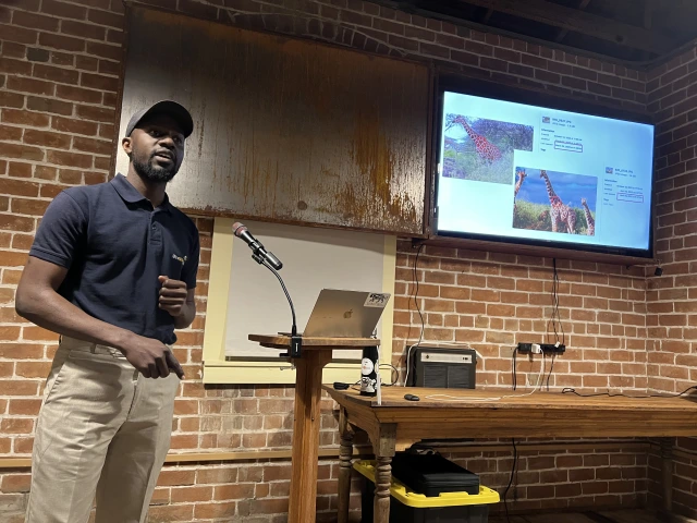 A man gives a presentation about giraffes. 